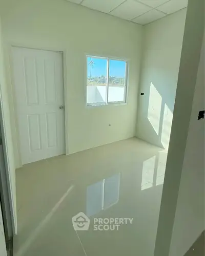 Bright empty room with glossy tiled floor and window view
