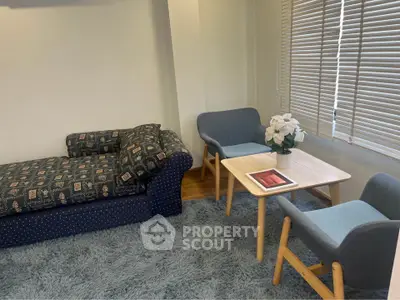 Cozy living room with stylish furniture and soft carpet, perfect for relaxation.