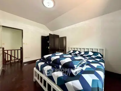 Spacious bedroom with modern decor and ample natural light