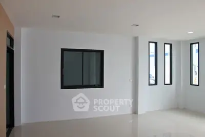 Spacious empty room with large windows and glossy tiled floor, perfect for customization.