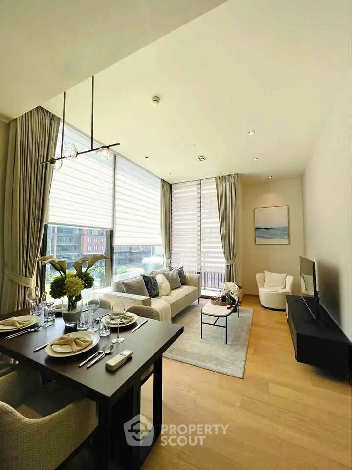 Luxurious modern living room with elegant dining area and large windows offering natural light.