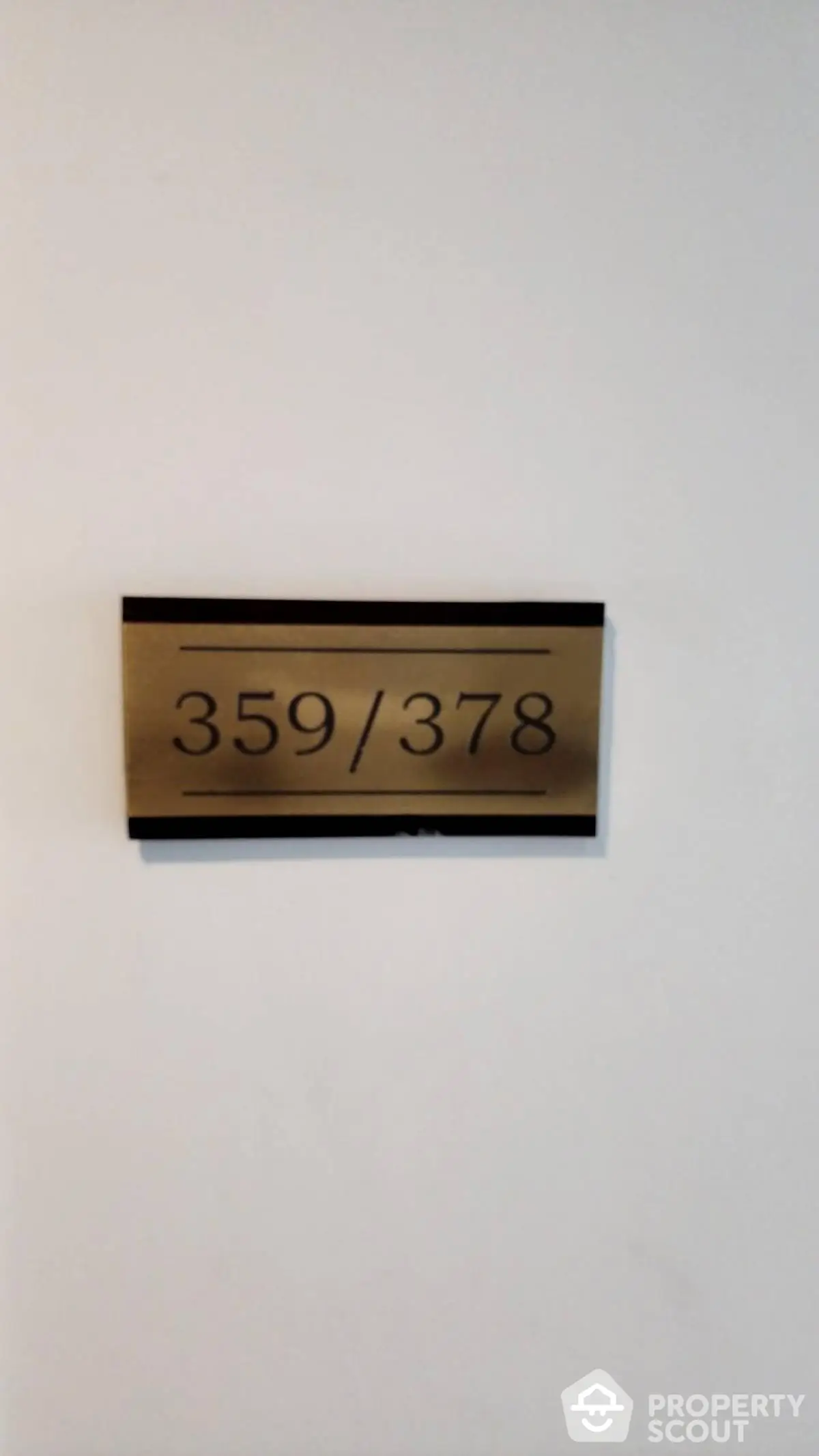 Apartment number plaque on a white wall indicating units 359 and 378.