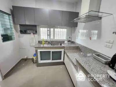 Modern kitchen with sleek cabinetry and granite countertops in a stylish home