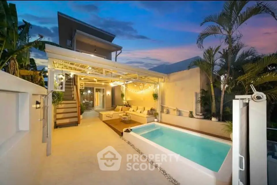 Luxurious outdoor pool area with modern seating and ambient lighting at sunset.