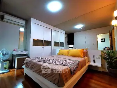 Spacious modern bedroom with stylish decor and ample storage space.