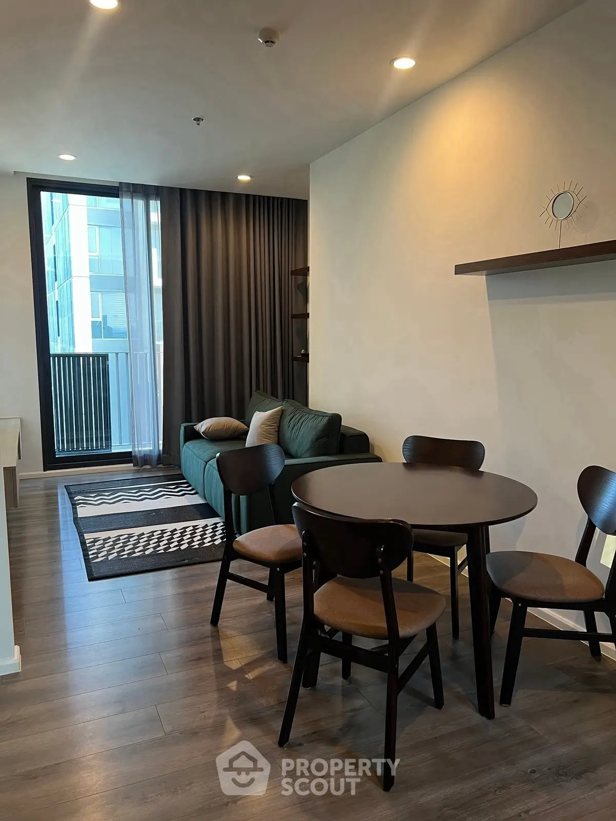 Modern living room with stylish furniture and large window in a contemporary apartment.