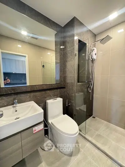 Modern bathroom with sleek fixtures and glass shower enclosure