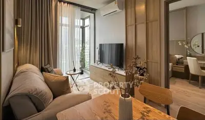 Modern living room with stylish decor and large windows offering natural light.