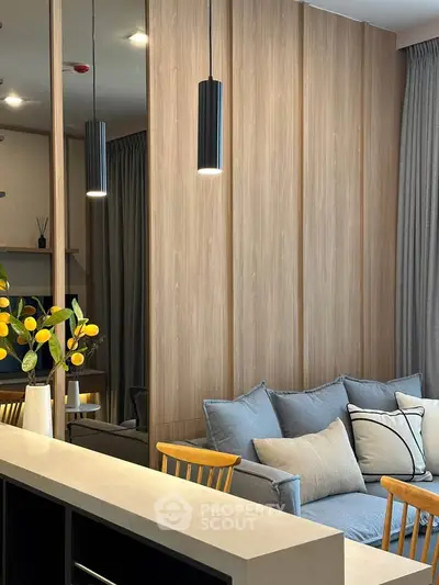 Modern living room with stylish decor, cozy sofa, and elegant lighting in a contemporary apartment.