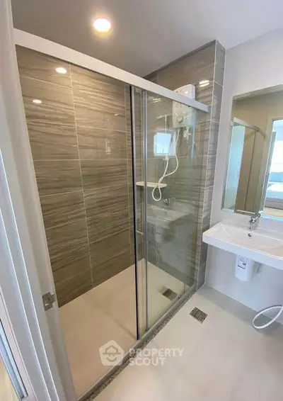 Modern bathroom with glass shower enclosure and sleek design
