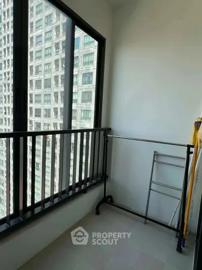 Modern apartment balcony with city view, ideal for urban living.