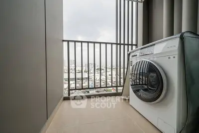 Modern balcony with washing machine and city view, ideal for urban living.