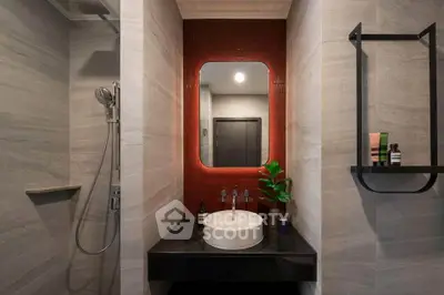 Modern bathroom with sleek design, featuring a stylish red-tiled mirror wall and contemporary fixtures.