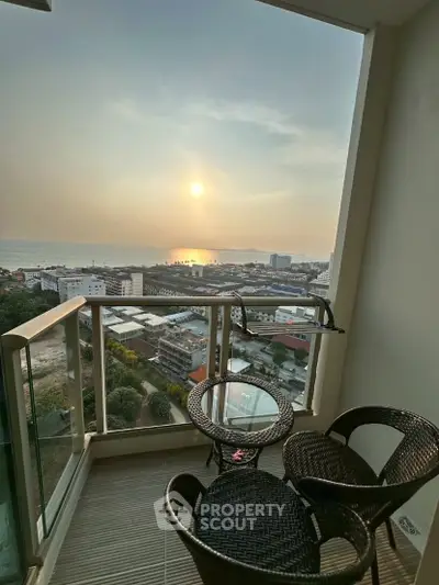 Stunning balcony view with ocean sunset, perfect for relaxation and enjoying panoramic cityscapes.