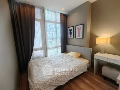 Cozy bedroom with large window and elegant decor