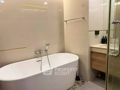 Modern bathroom with freestanding bathtub and sleek vanity