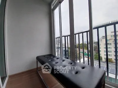Stylish balcony with modern seating and city view, perfect for relaxation and enjoying the skyline.