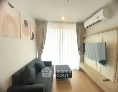 Modern living room with sleek furniture and large window for natural light.