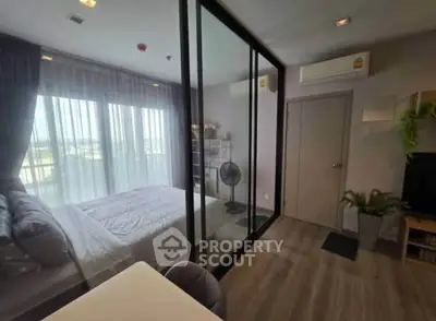 Modern bedroom with glass partition and natural light in stylish apartment