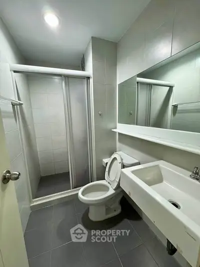 Modern bathroom with shower and sleek fixtures in a contemporary home.