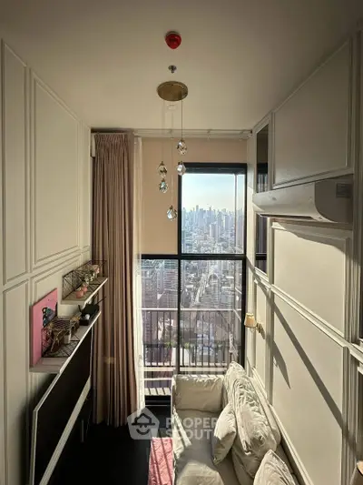 Modern living room with city view, featuring elegant decor and large windows for natural light.