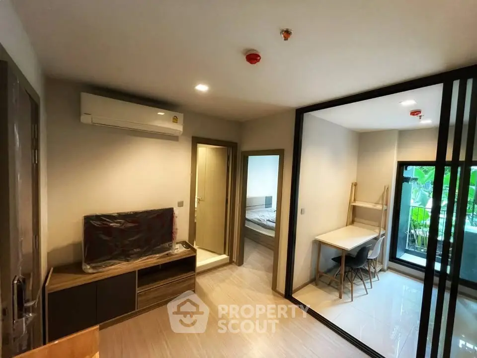 Modern apartment interior with open living space and balcony view