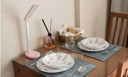 Cozy dining setup with elegant tableware and ambient lighting in a stylish home interior.