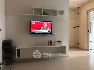 Modern living room with wall-mounted TV and minimalist decor