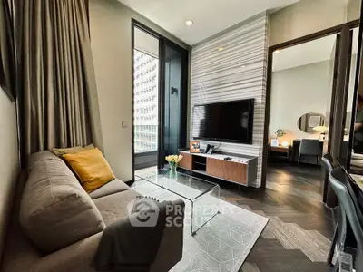 Modern living room with sleek design, large TV, and cozy seating area in a stylish apartment.