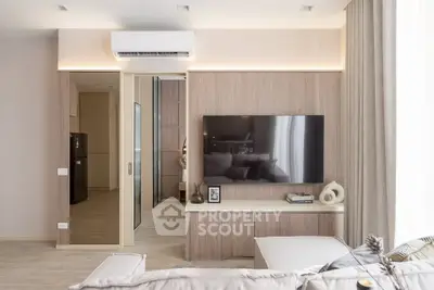 Modern living room with sleek design, large TV, and stylish decor in a contemporary apartment.