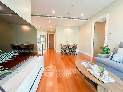 Spacious living room with modern decor and wooden flooring