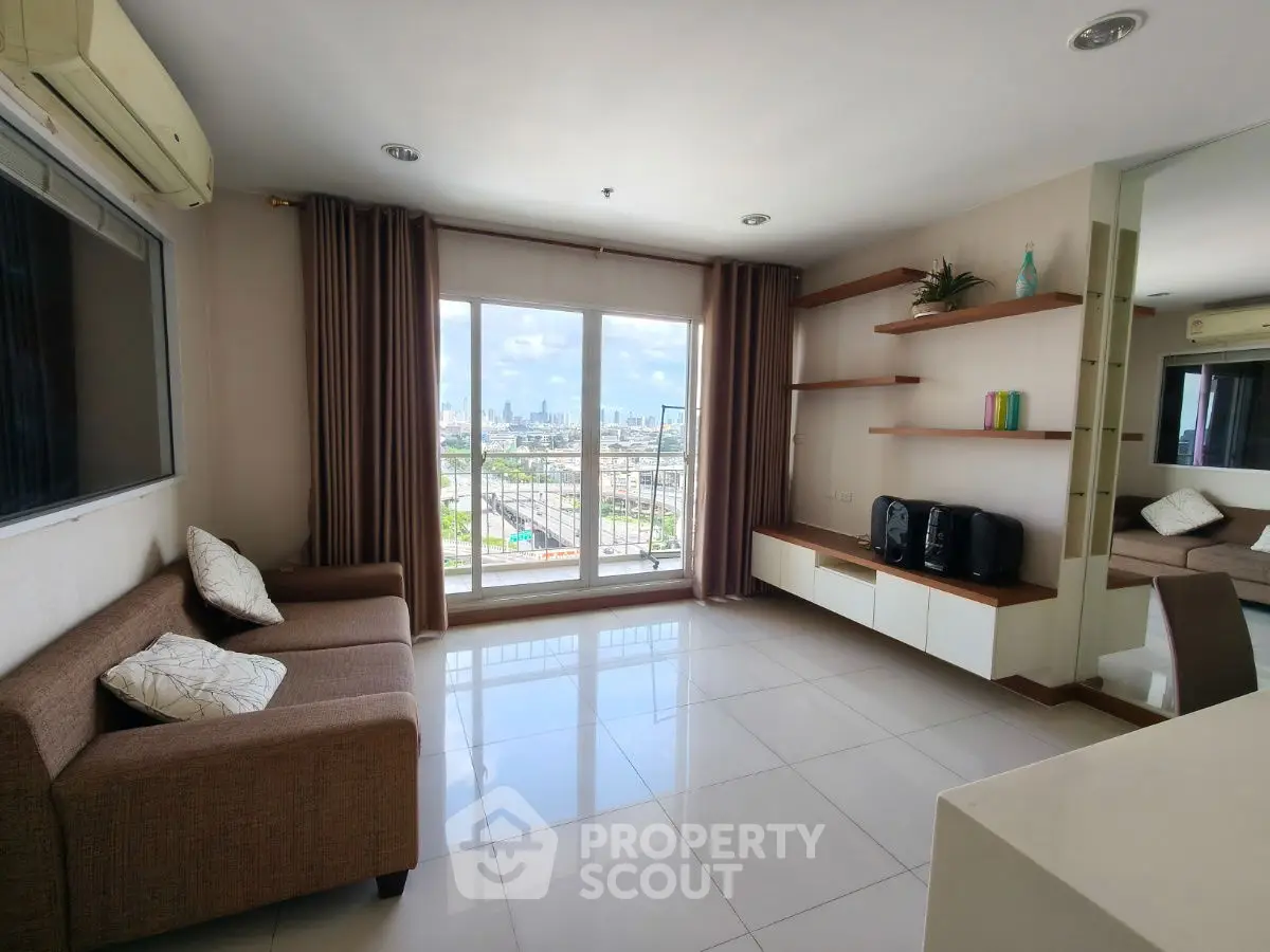 Modern living room with city view, featuring sleek furniture and large windows.
