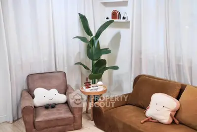 Cozy living room with plush seating and playful decor, perfect for relaxation and comfort.
