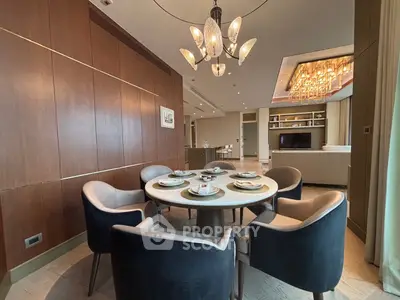 Luxurious dining area with elegant chandelier and modern decor in upscale apartment