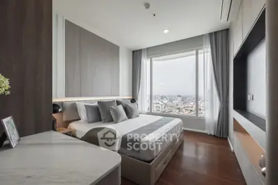 Luxurious bedroom with city view, modern decor, and elegant furnishings.