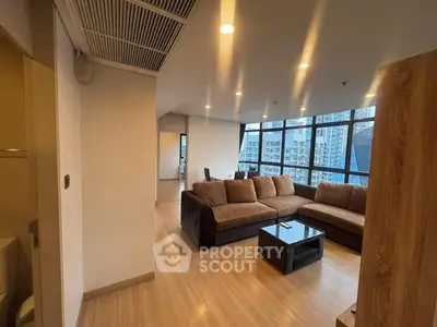 Spacious modern living room with large windows and city view