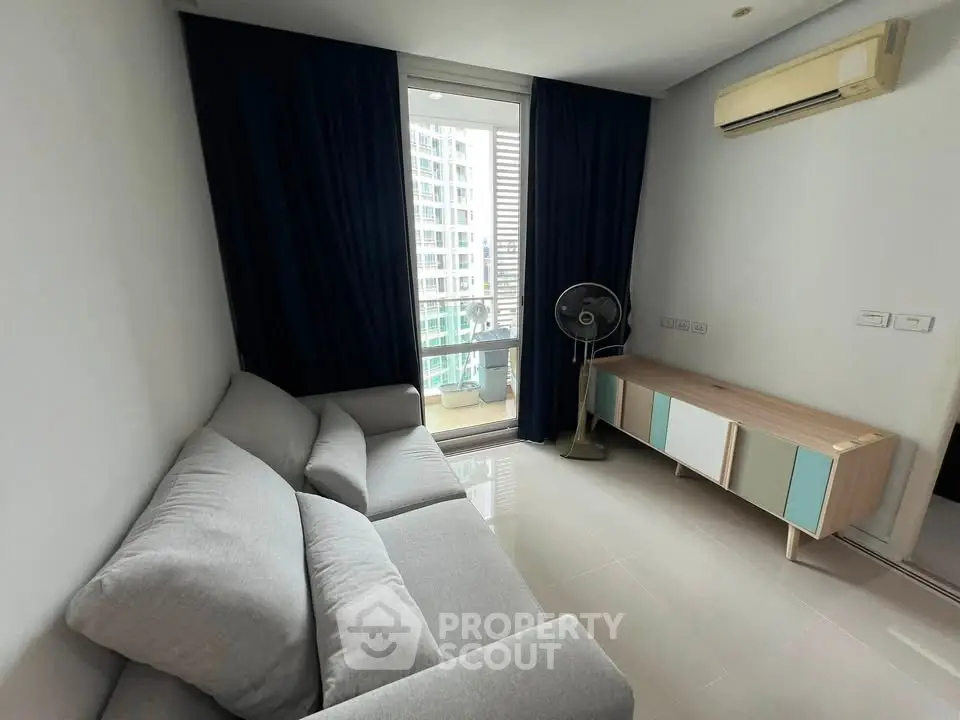 Modern living room with sleek furniture and city view from window