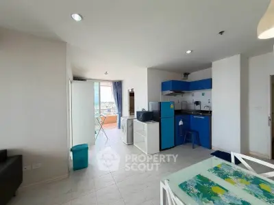 Modern open-plan kitchen and living area with balcony view in bright apartment