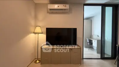 Modern living room with sleek TV setup and stylish air conditioning unit.