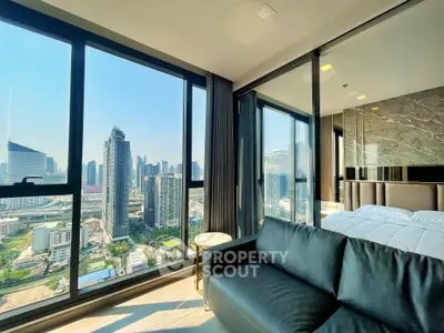 Luxurious corner unit with stunning city view, featuring modern living room and bedroom with floor-to-ceiling windows.