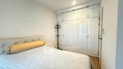 Spacious bedroom with elegant built-in wardrobe and cozy bed setup