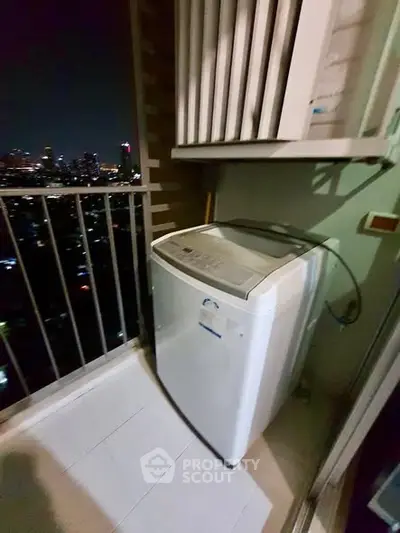 Compact balcony with washing machine and city night view