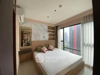Modern bedroom with large windows offering city views, featuring stylish decor and ample natural light.