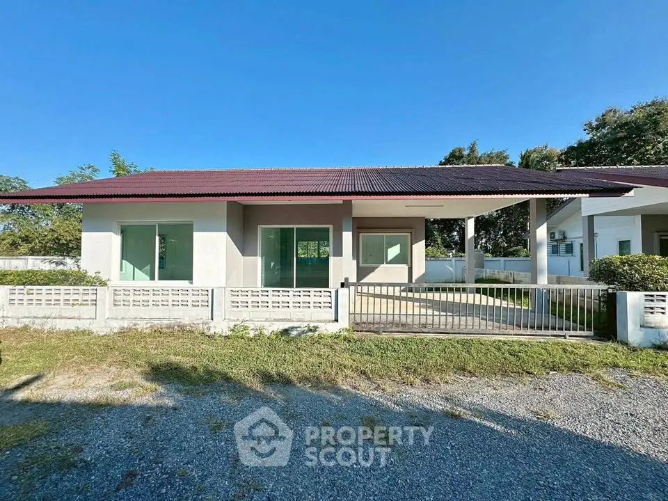 Charming single-story home with spacious front yard and modern design.