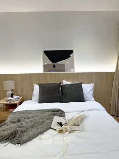 Cozy bedroom with modern decor and soft lighting, perfect for relaxation.