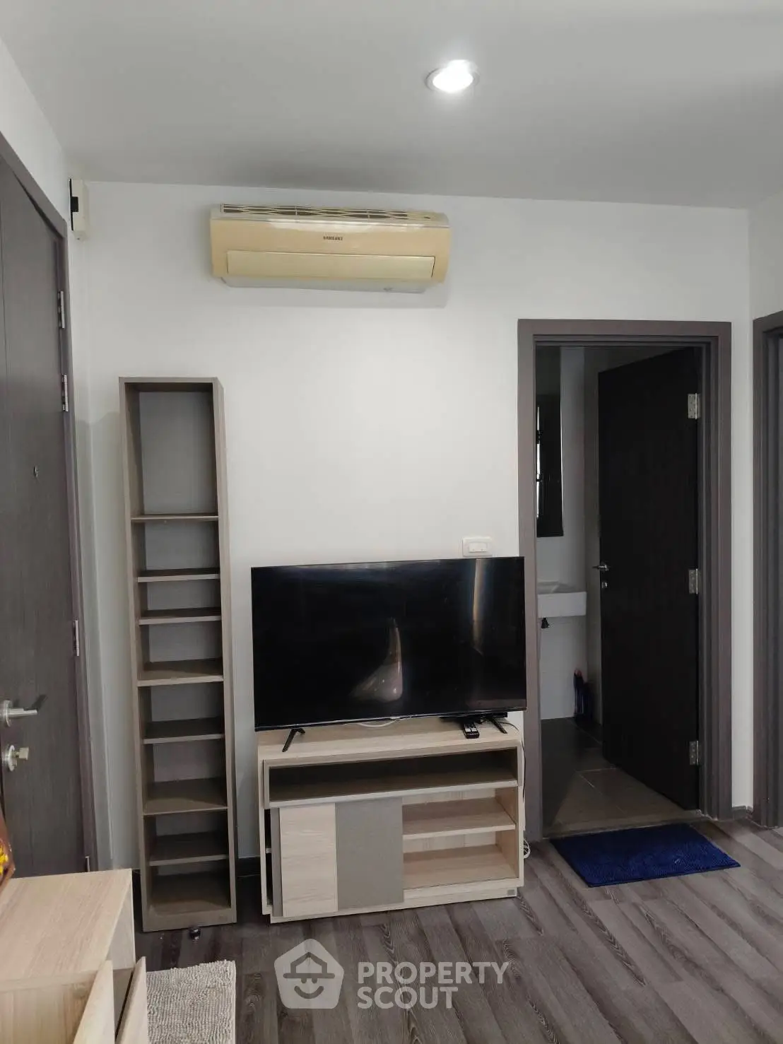 Modern living room with sleek TV setup and air conditioning