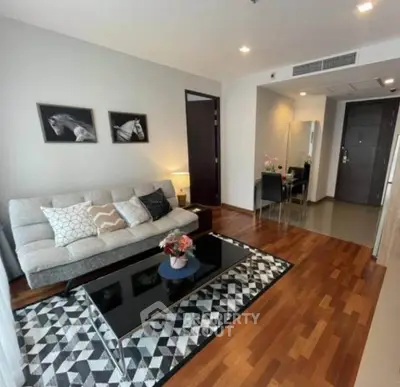 Modern living room with stylish decor and wooden flooring in a cozy apartment.