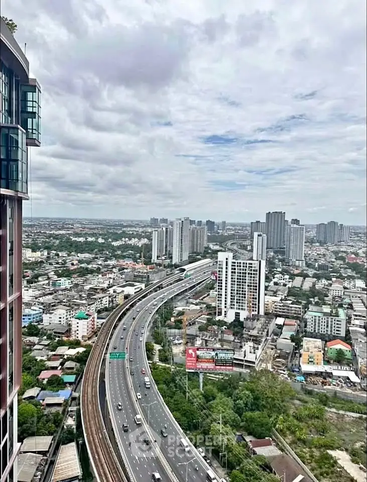 Stunning cityscape view from high-rise building showcasing urban skyline and highway.