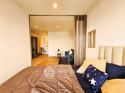 Modern bedroom with cozy decor and sliding partition to living area