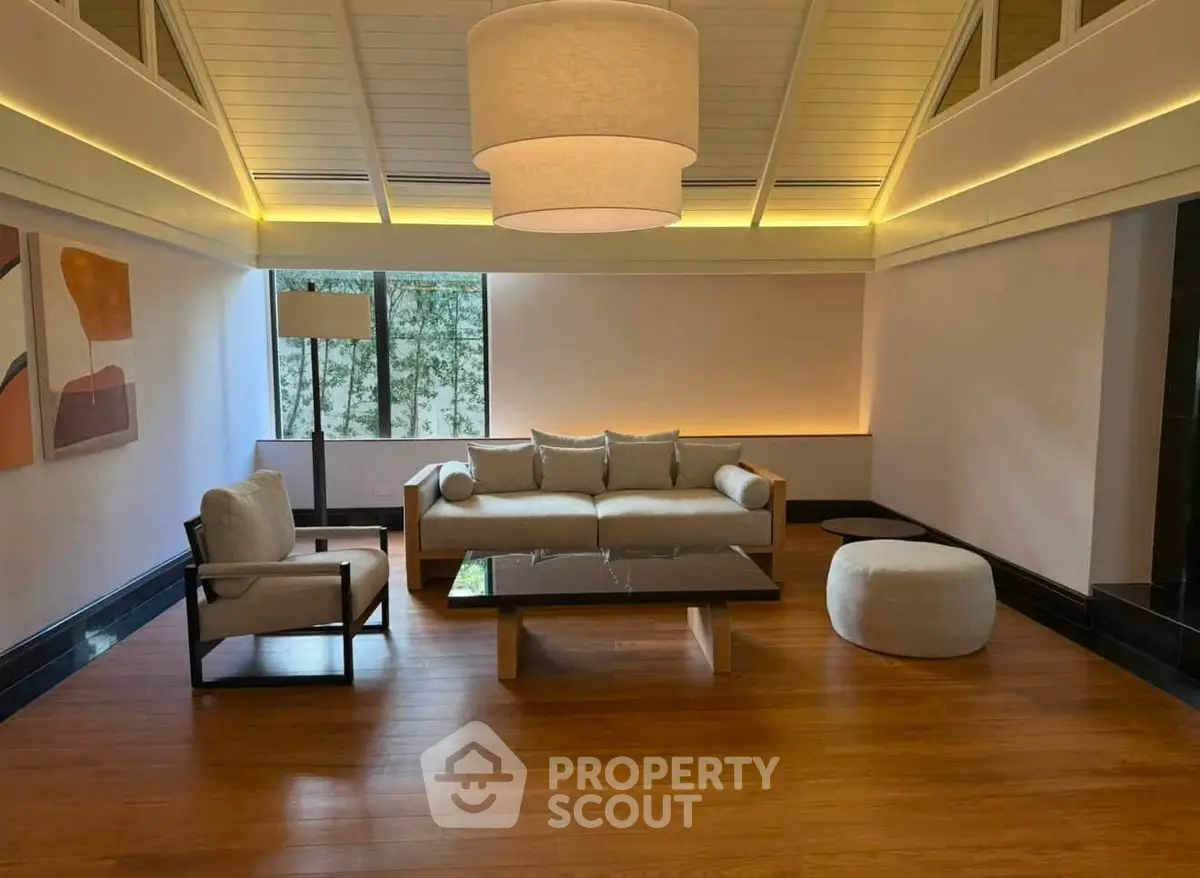 Elegant living room with modern furniture and ambient lighting, featuring a stylish ceiling design.